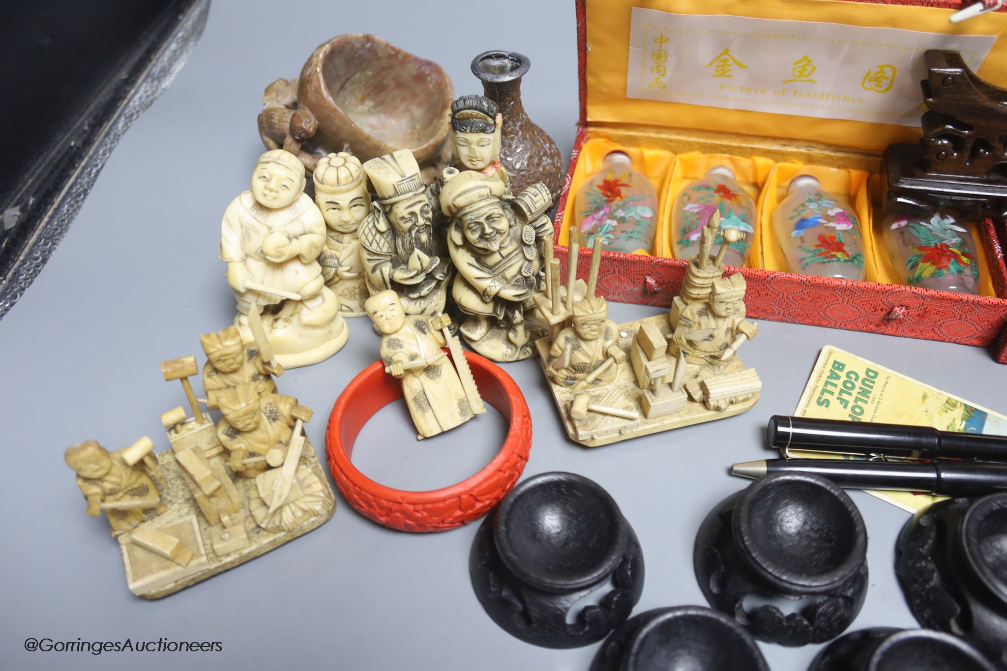 A collection of miscellaneous snuff bottles, figurative carvings, stands etc